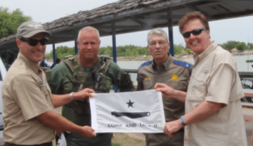 Senator Dan Patrick and DPS Director Steve McCraw pose with a message for border-crossers in Mission, Texas.