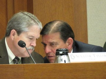 Sen. Larry Taylor (R-Friendswood) confers with Sen. Eddie Lucio (D-Brownsville)