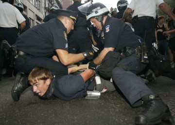 This Aug. 31, 2004 file photo shows a protester being arrested by New York City Police officers during the Republican National Convention in New York. New York City agreed Jan. 15, 2014, to pay $18 million to settle dozens of lawsuits filed by protesters, journalists and bystanders who said they were wrongly arrested at the 2004 Republican National Convention.