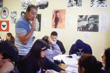 David Arriaga checks on students in his Mexican-American studies class at Houston’s Stephen F. Austin High School in April.