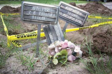 Grave markers next to a Brooks County burial plot marked for exhumation in May 2013 by the Baylor University forensics team.