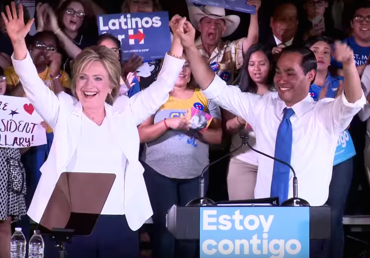 Hillary Clinton and Julian Castro grasp hands and cheer.