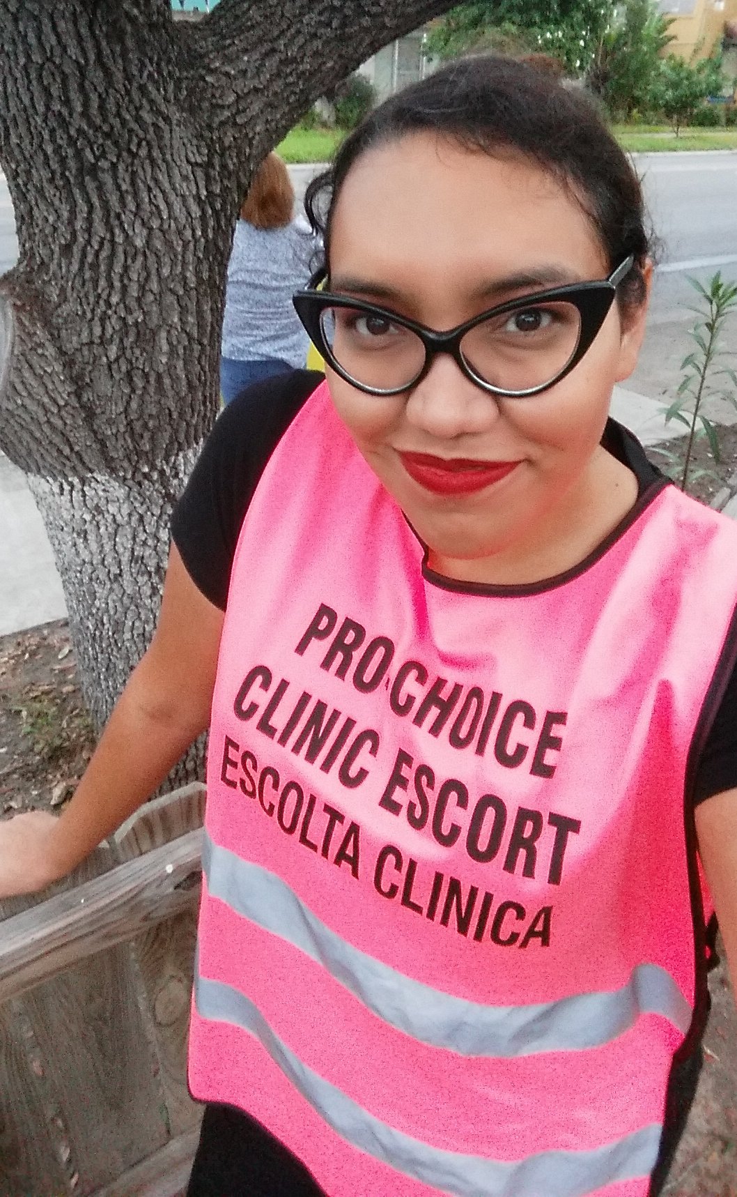 Melissa Arjona wears a pink vest that reads "Pro-choice clinic escort" and "Escolta clinica."
