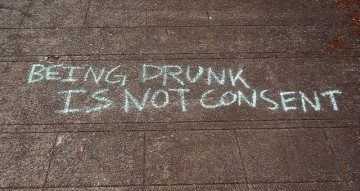 'Being Drunk Is Not Consent' written on the ground in sidewalk chalk.