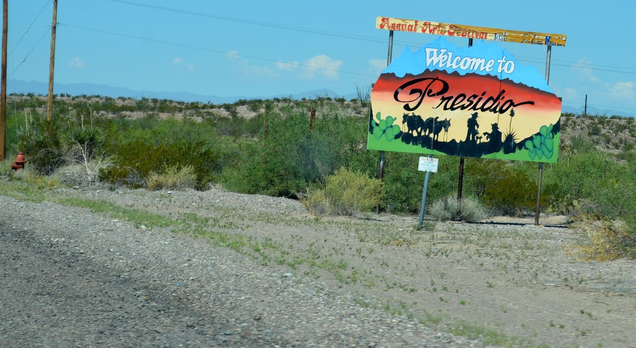 A "Welcome to Presidio" sign at the Texas-Mexico border.