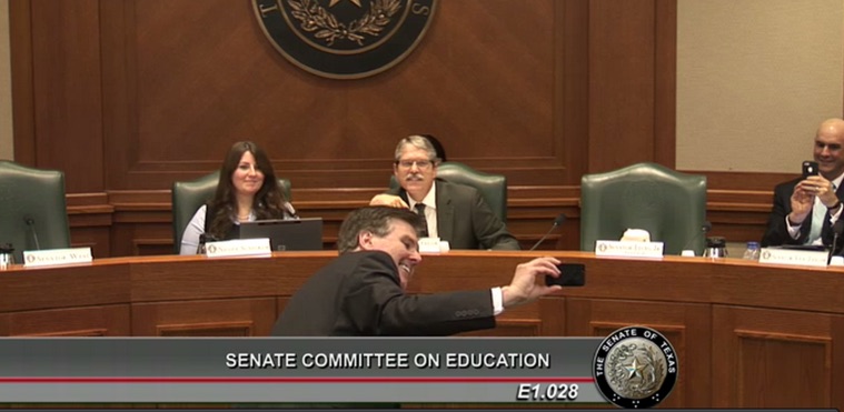 Lieutenant Governor Dan Patrick takes a photograph of himself using the camera technology on a smartphone.