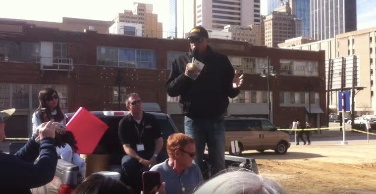 Pastor Stephen Broden preaches the pro-gun word from the back of a pick up truck at a Dallas protest of a Presbyterian church-sponsored gun buyback.