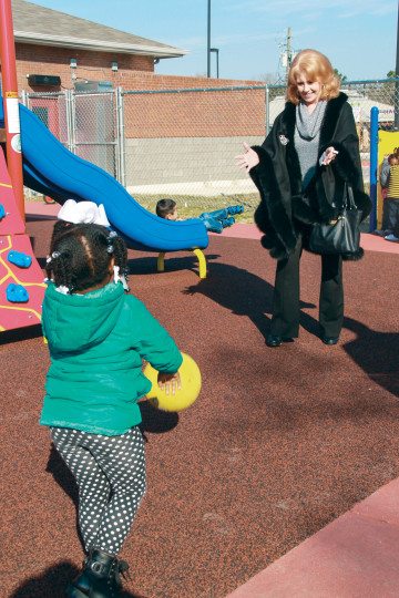 Kay Smith plays catch at a Head Start playground.