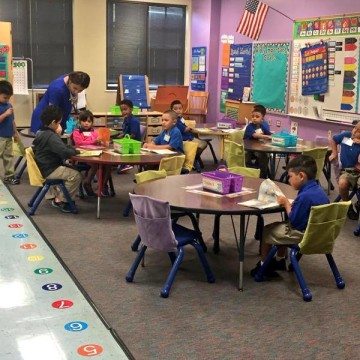 Houston ISD elementary schoolers working at group tables.