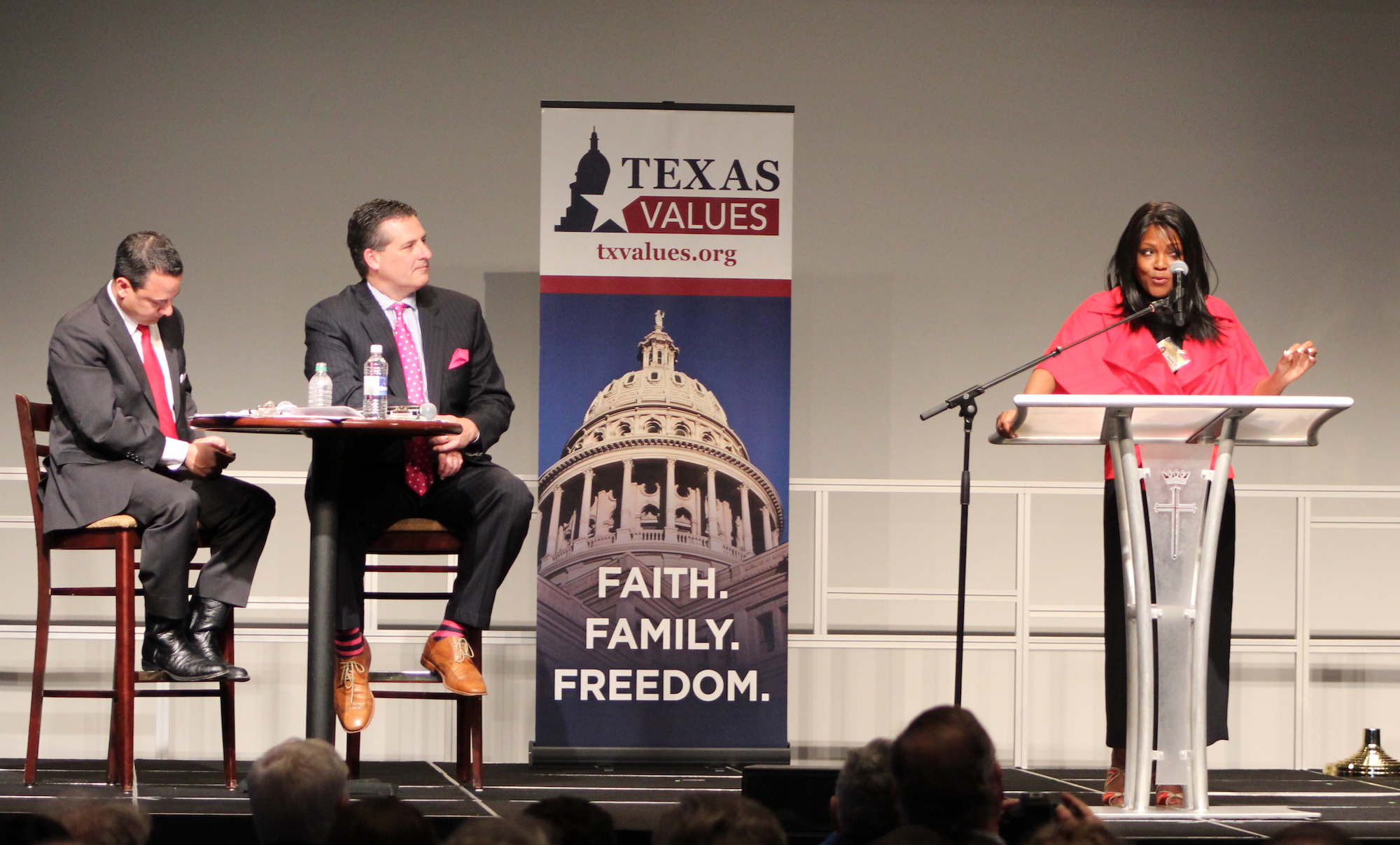 Democratic House candidate Denise Hamilton spoke Monday night during a forum at Prestonwood Baptist Church in Plano as moderators Dan Panetti, worldview director at Prestonwood Christian Academy, and Texas Values President Jonathan Saenz look on.
