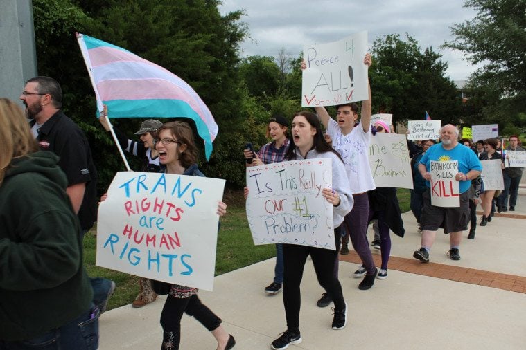 About 100 LGBT Texans, supporters and allies marched outside Rockwall City Hall Monday night to protest the mayor's proposal to criminalize some trans people for using public restrooms. Bathroom ordinance
