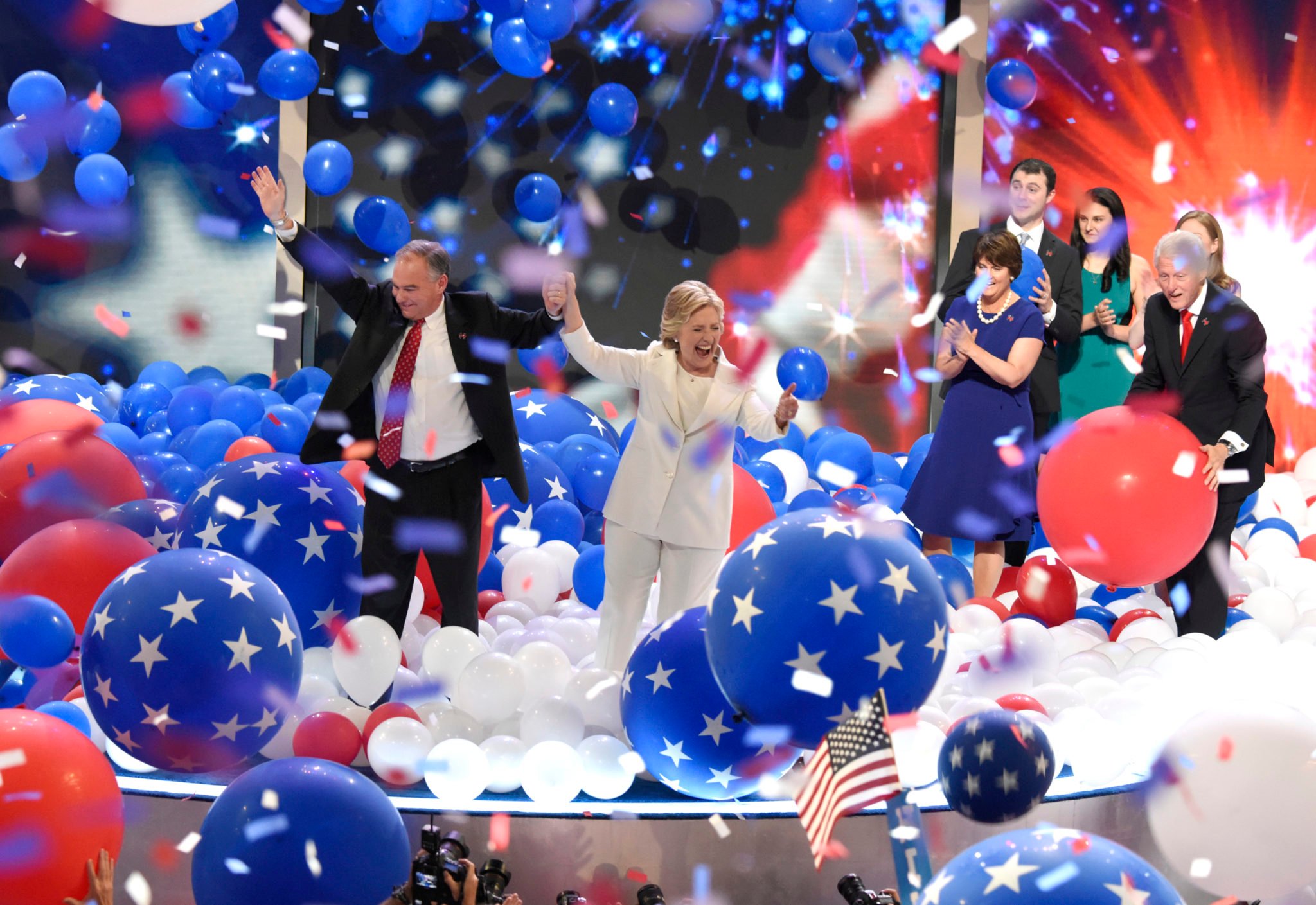 Hillary Clinton and Tim Kaine join hands as balloons drop on the last night of the 2016 Democratic National Convention in Philadelphia.
