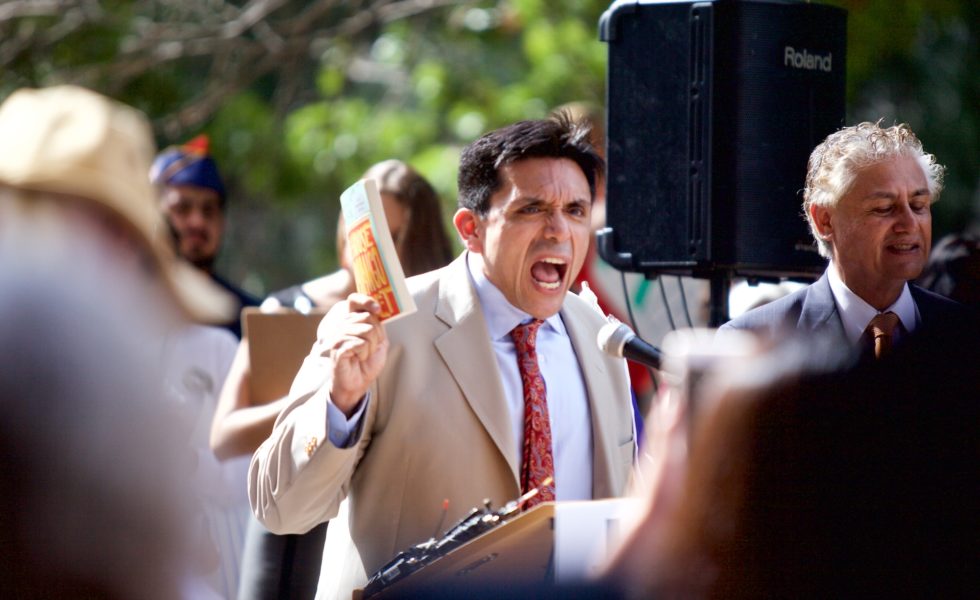 Houston activist and author Tony Diaz speaks at a rally against the textbook