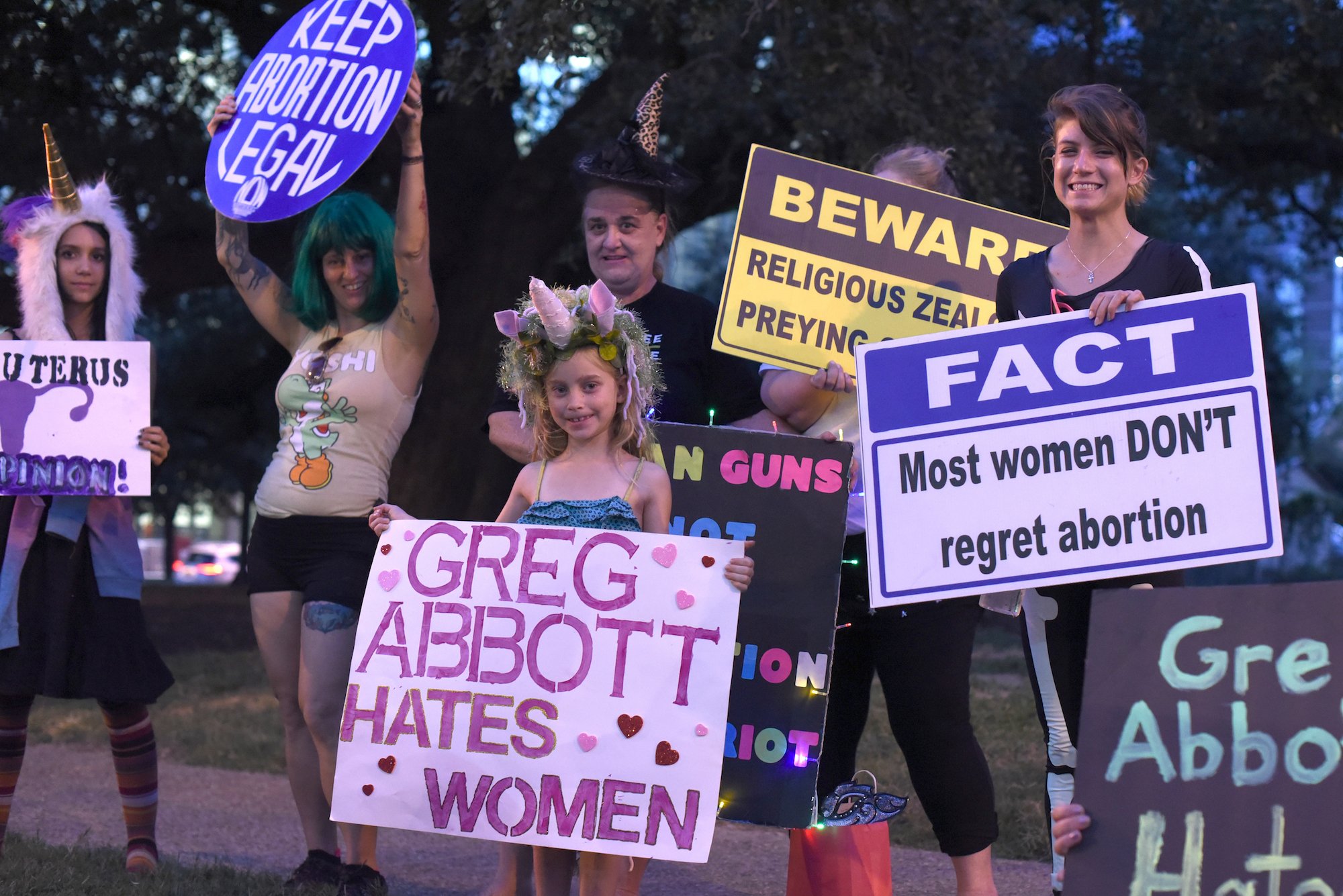 Lexie Cooper, right, and other members of the National Organization for Women, protest the Texas Alliance for Life annual benefit dinner in Austin.