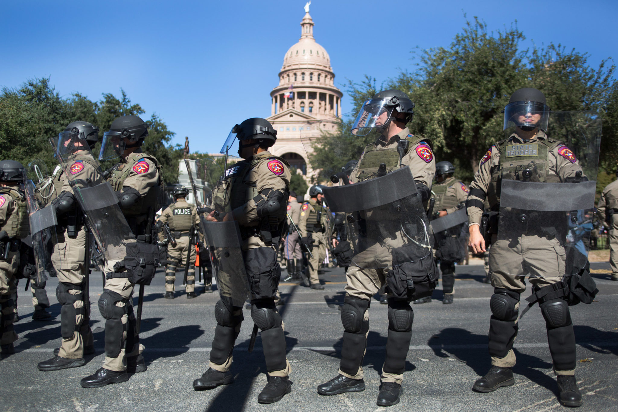 Police wore riot gear outside the Texas Capitol as armed "White Lives Matter Too" demonstrators clashed with counter-protesters.