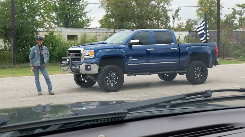 A man flies a "blue lives matter" flag behind his truck.