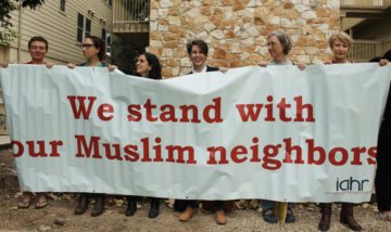 Demonstrators with Interfaith Action for Human Rights held an anti-Islamophobia banner.