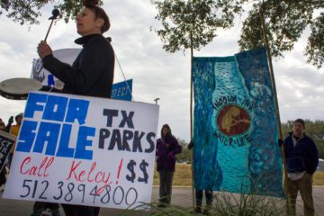 About 50 protesters gathered outside the Texas Parks and Wildlife Department demanding Commissioner Kelcy Warren's resignation.