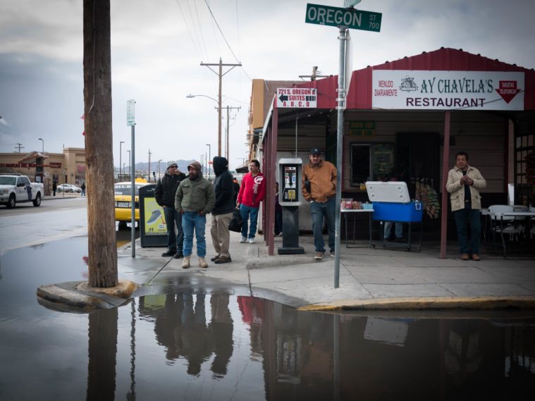 Onlookers watch more than 1,000 activists march through the streets of El Paso.