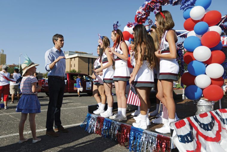 O’Rourke talks to cheerleaders from Roosevelt High School with his daughter Molly.