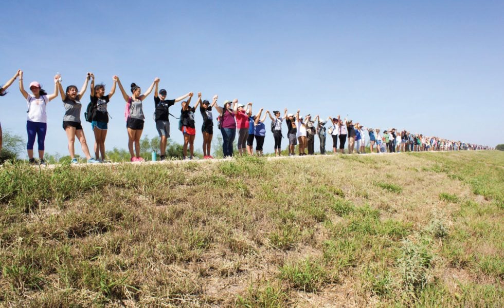 Protesters form a human chain on the levee at the Santa Ana refuge.