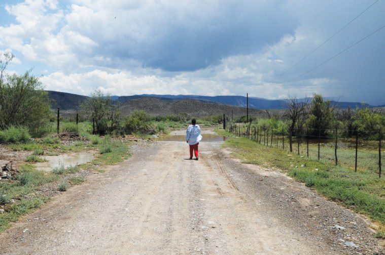 A woman walks in the Mexican town of San Antonio del Bravo after a monsoon.