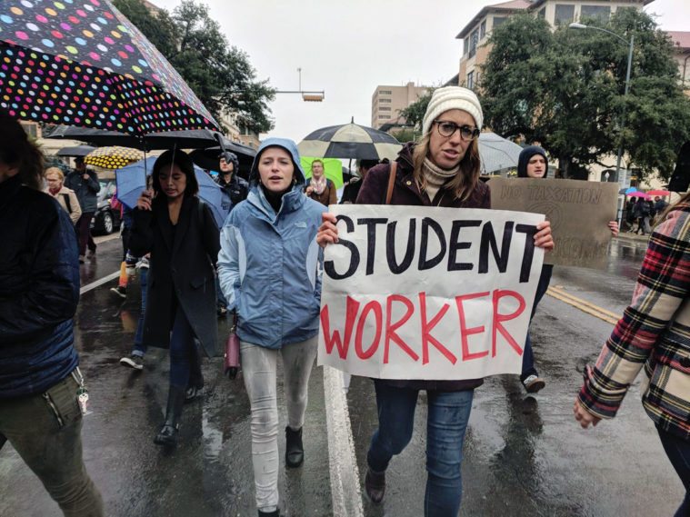 Graduate students marched through the UT-Austin campus Wednesday.