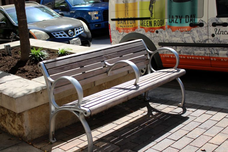 The armrest in the middle of this bench makes it impossible to lie down.