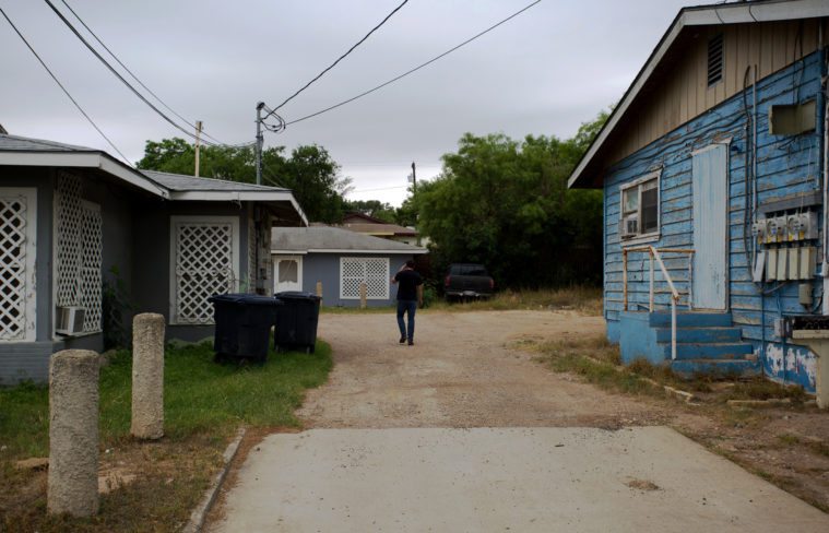 Rick Treviño walks down a dirt driveway in Eagle Pass looking for a door to knock on.