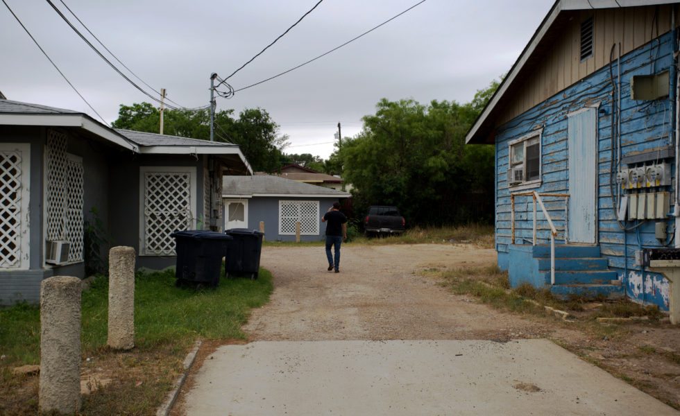 Rick Treviño walks down a dirt driveway in Eagle Pass looking for a door to knock on.