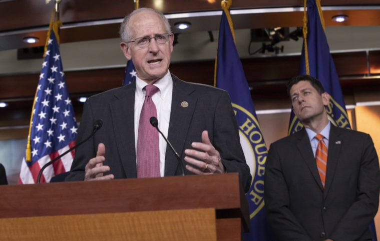 Representative Mike Conaway, joined at right by House Speaker Paul Ryan, touts a draft of the Farm Bill during a news conference in Washington, D.C.