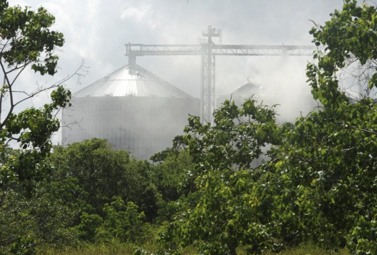 Firefighters spray water on a silo to cool 10,000 tons of smoldering wood pellets at the German Pellets storage silo at Port Arthur in 2017.