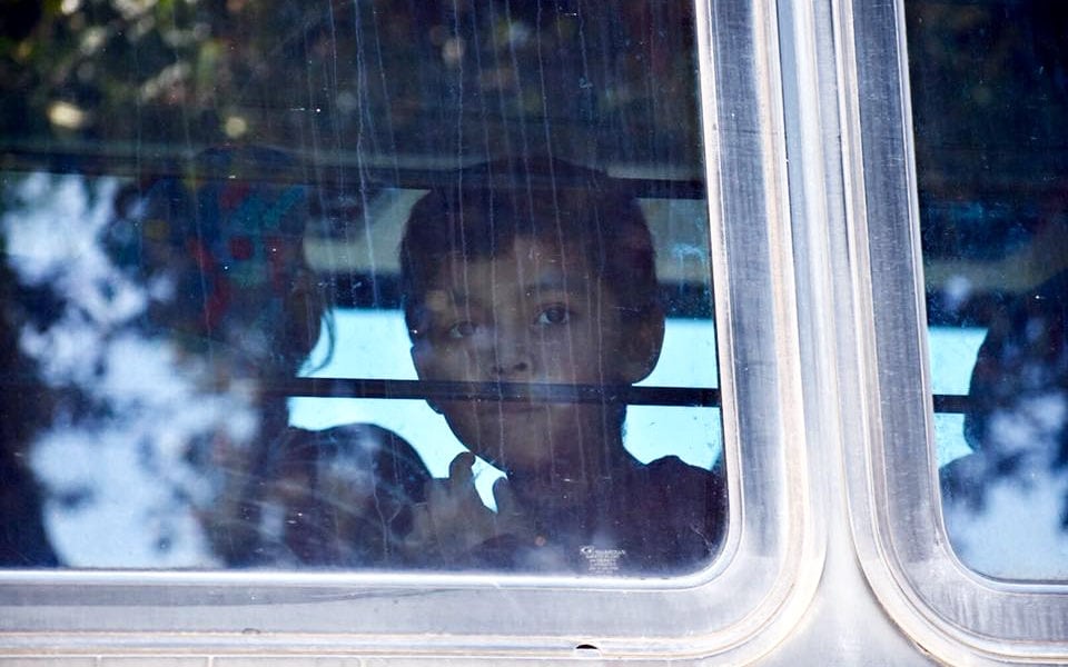 Children leave a detention center on a bus in 2018.