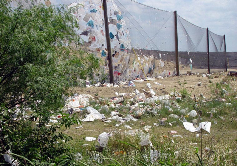 Even when plastic bags are properly disposed of, they often escape landfills during the collection process. This photo shows trash collecting around the Austin BFI Waste Management facility.
