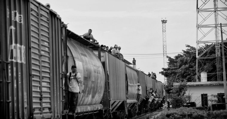 Migrants riding atop <em>La Bestia</em> in Mexico.