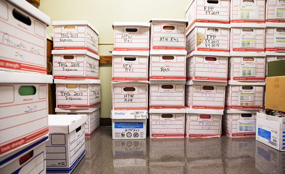 Boxes of program and audit records filling one exam room in the Heidi Clinic.