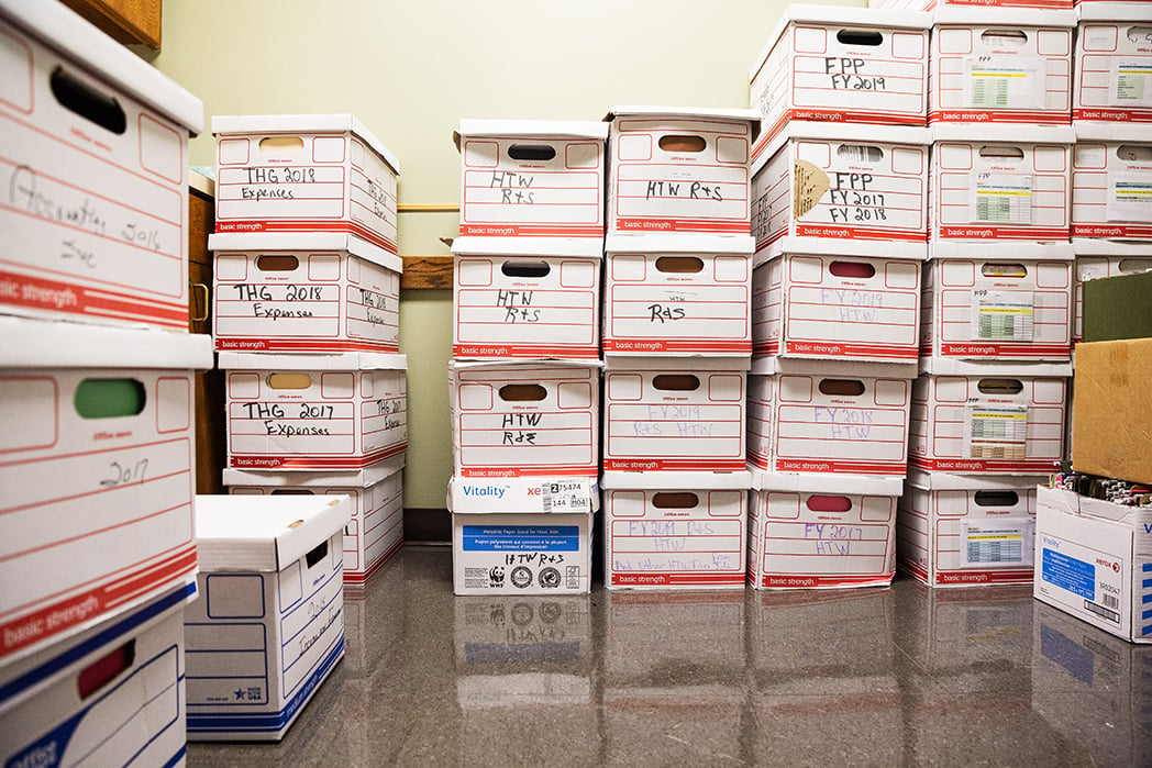 Boxes of program and audit records filling one exam room.