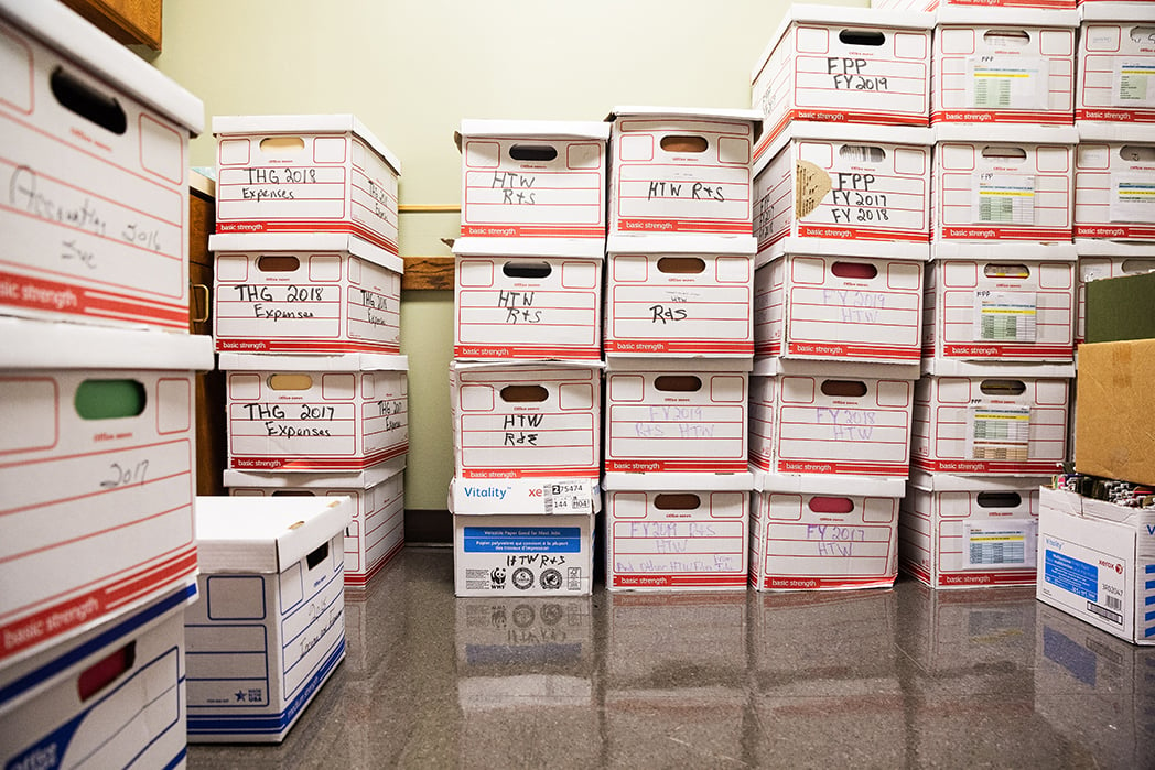 Boxes of program and audit records fill one exam room.