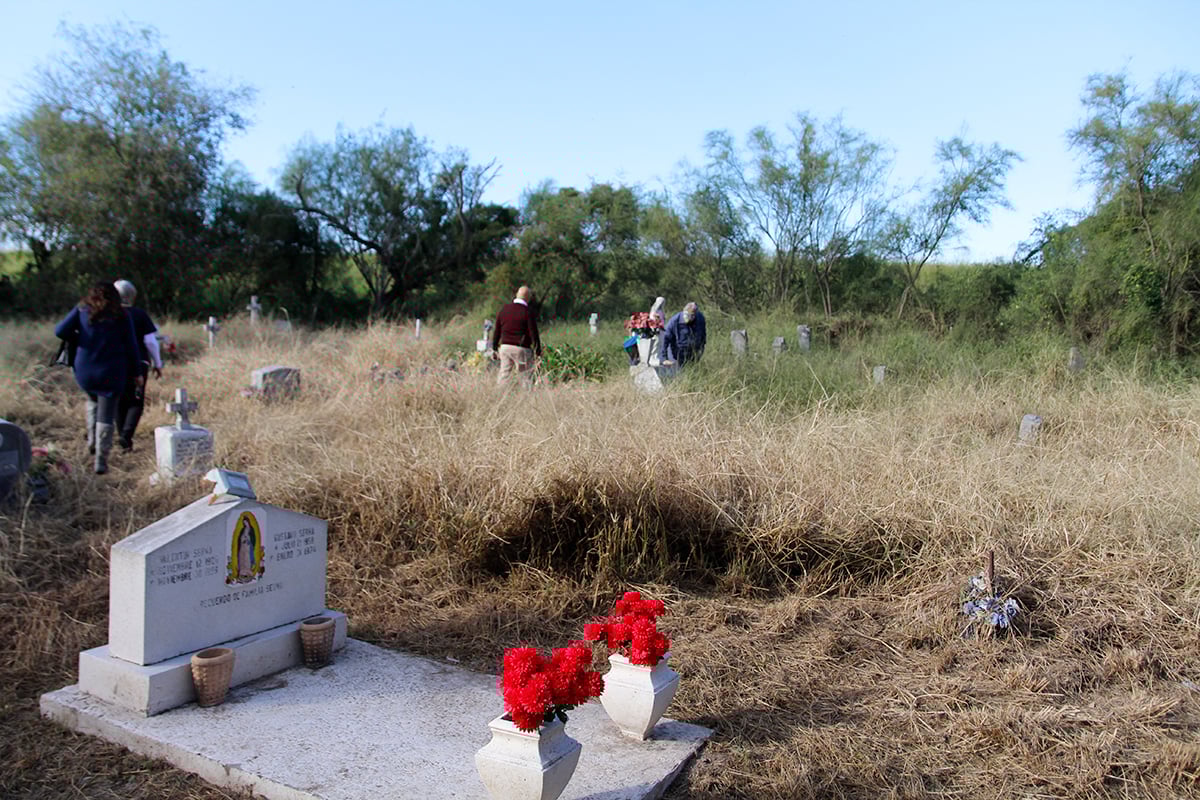 Descendants of those buried in the Eli Jackson Cemetery visit the graveyard in November. Activists have since cleared the cemetery of grass and weeds.