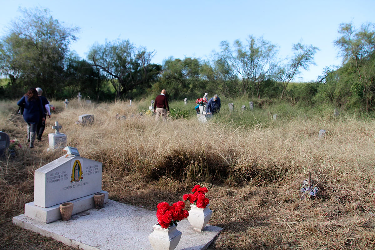 Descendants of those buried in the Eli Jackson Cemetery visit the graveyard in November. Activists have since cleared the cemetery of grass and weeds.