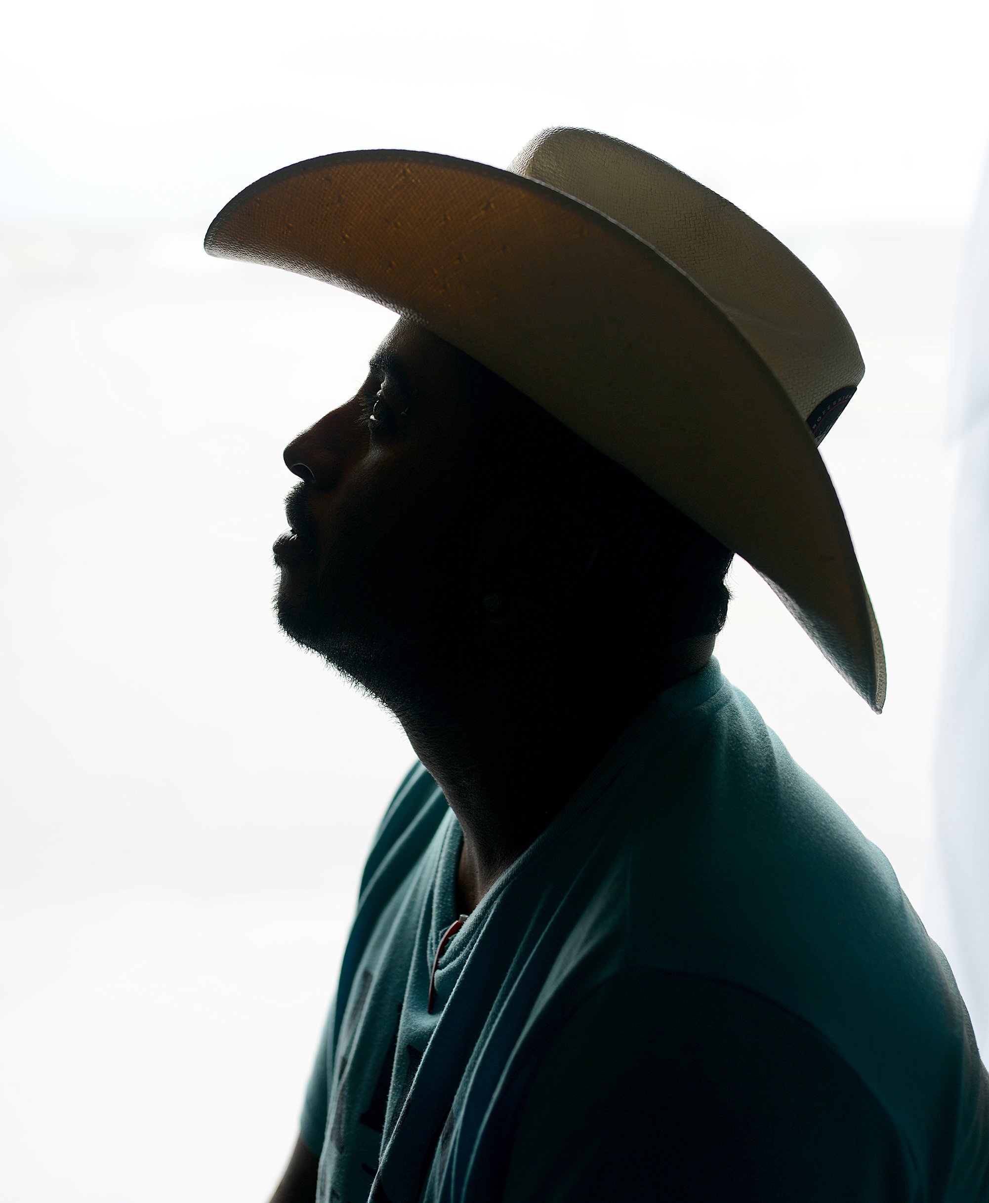 A Mexican farmworker in Plainview on an H-2A visa sits for a portrait. Because an H-2A visa is bound to one employer who controls housing and worksites, these farmworkers are uniquely at risk of being forced into labor.