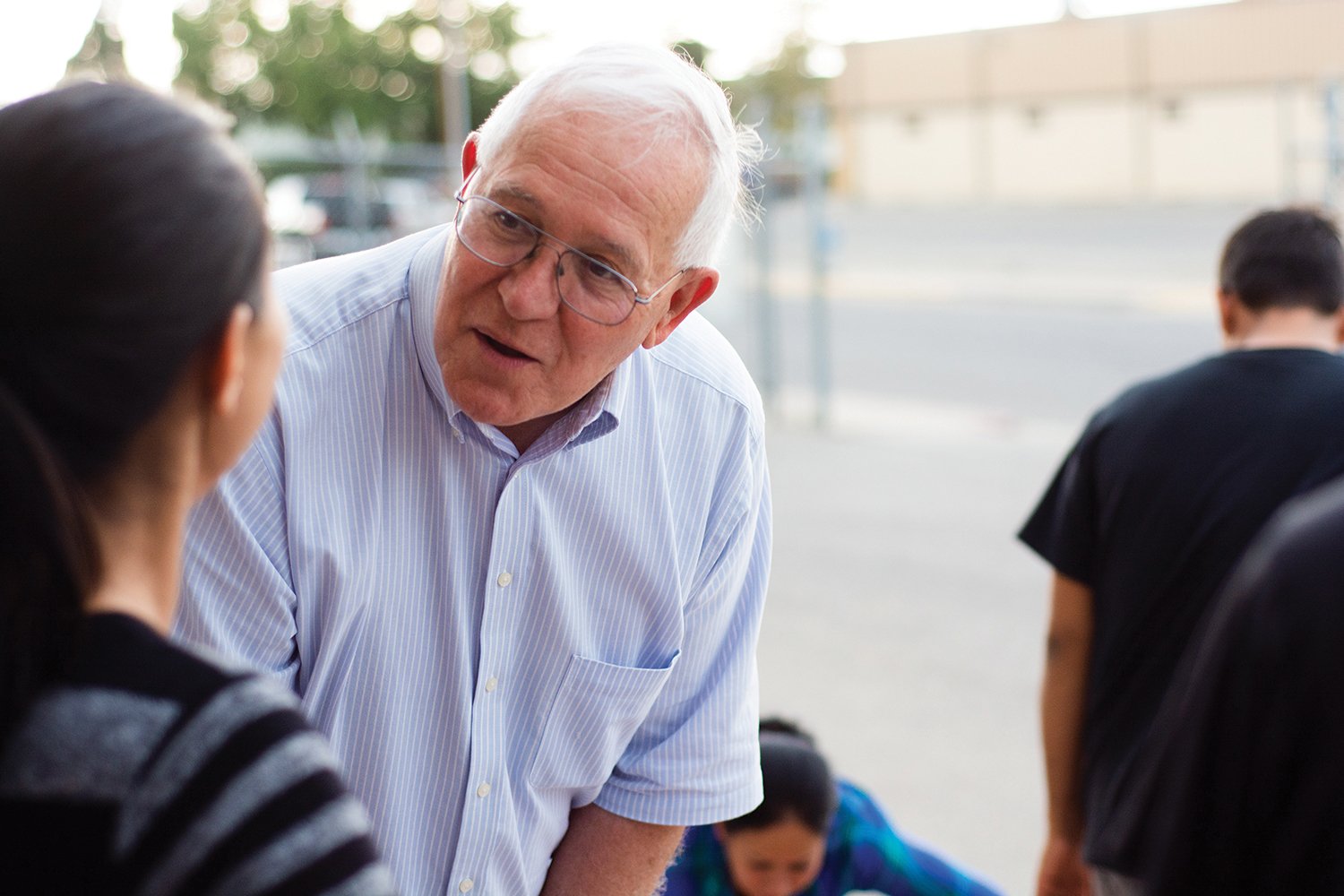 Ruben Garcia speaks to a migrant mother as she and her son depart an Annunciation House shelter for the final time, traveling to her U.S.-based sponsor.