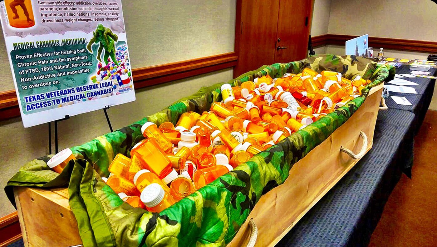 A casket filled with pill bottles used by Texas Veterans for Medical Marijuana to represent the growing opioid crisis.