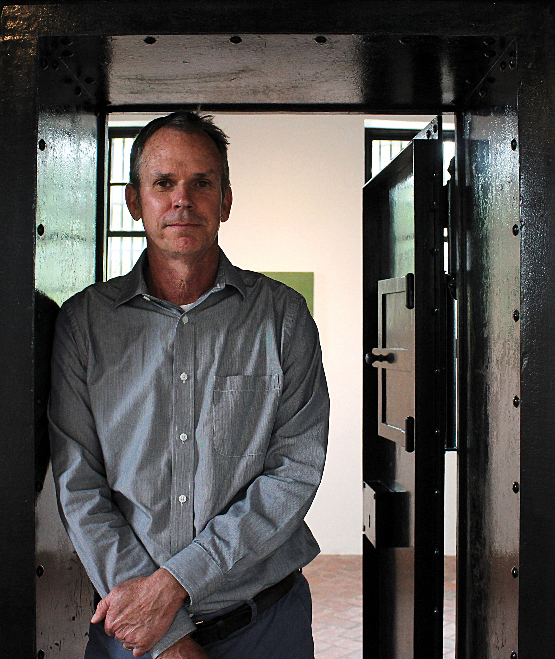 Executive Director Patrick Kelly stands in the old jail building.
