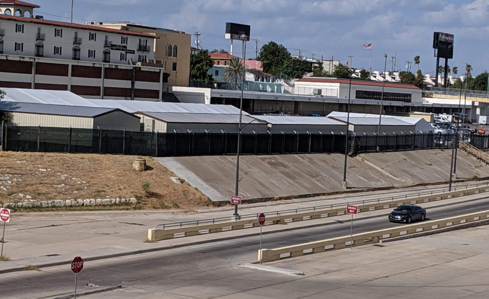 Migrants must attend court in a hastily constructed tent facility near an international bridge in Laredo.