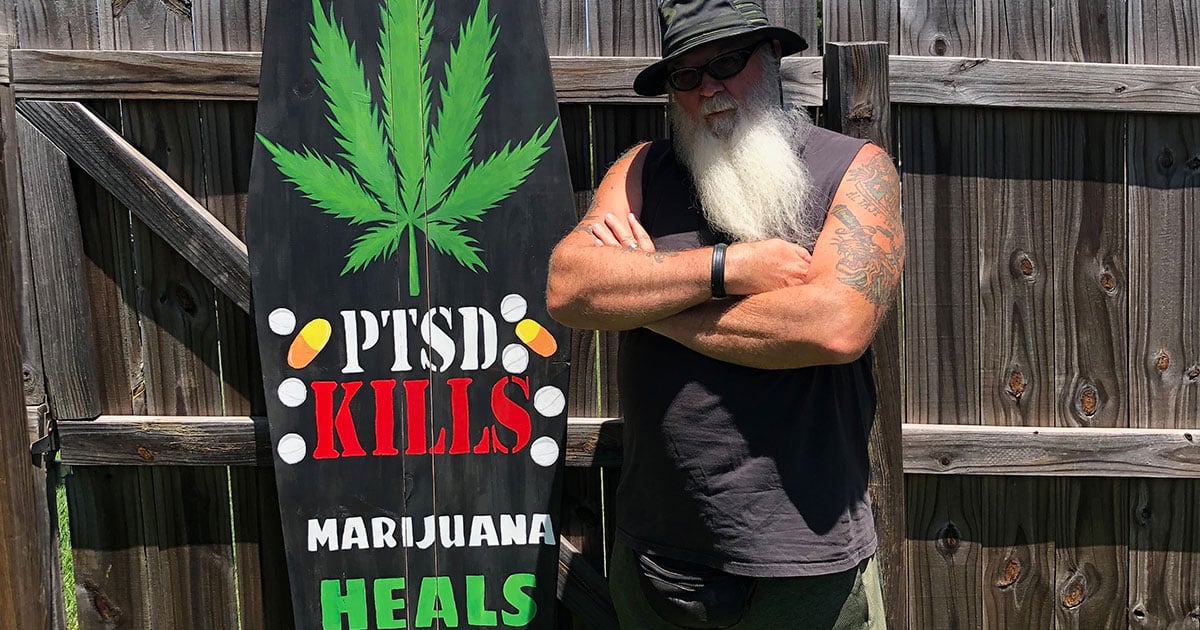 Dave Bass stands next to a military-style casket he uses at Texas Veterans for Medical Marijuana events.