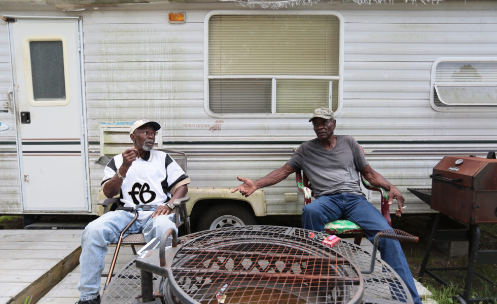 Henry Wilson, right, jacked up his storm-damaged house with his friend, Lester Owens, left. Wilson has lived in a trailer next to his house in Port Arthur for the past two years.