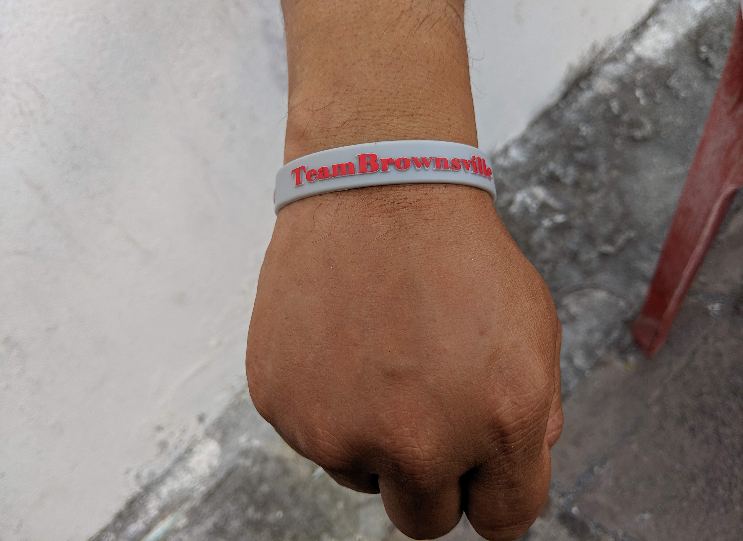 An asylum-seeker in Matamoros sports a Team Brownsville bracelet.