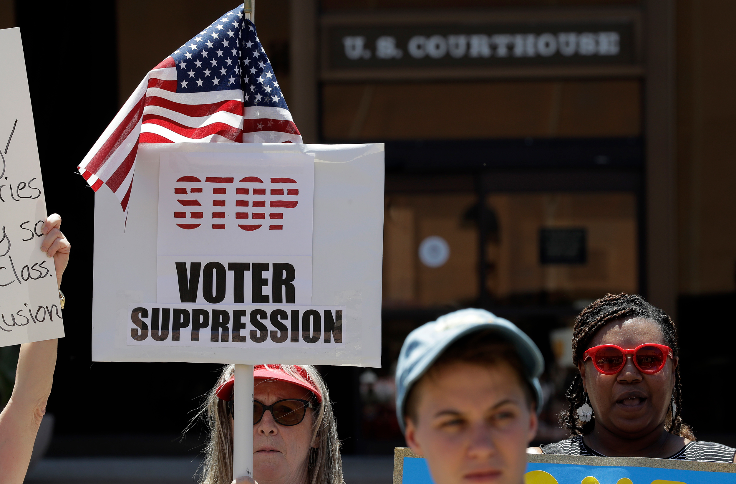 Protesters gather outside the federal court house, Monday, July 10, 2017, in San Antonio, where a redistricting trial is taking place. Federal courts earlier this year found that Texas passed election laws to purposefully discriminate against Hispanic and black voters and the trial starting today could redraw Texas voting maps before 2018 and bolster Democratic efforts to reclaim Congress.