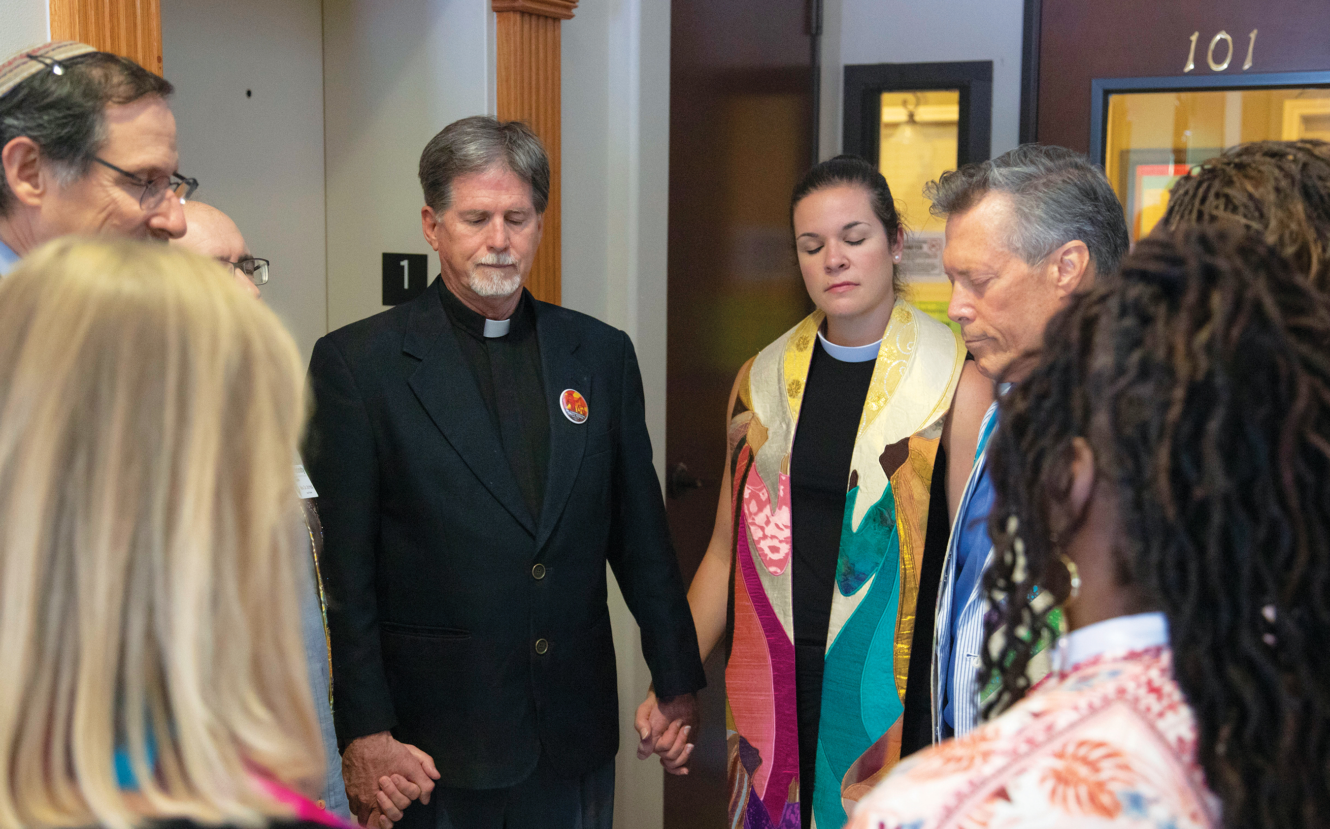 Christian and Jewish faith leaders join in a prayer circle at the Whole Woman's Health clinic blessing in July.